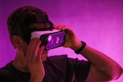 A guest tests out Minecraft for VR Gear, while wearing Oculus goggles, during demonstration of the Minecraft for Gear VR