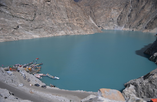 In this photograph taken on on August 3, 2015, Pakistani residents board boats used to cross Attabad Lake, which was formed following a landslide in January 2010, in Pakistan's Gojal Valley. Karachi, 2050: The sprawling megacity lies crumbling, desiccated by another deadly heat-wave, its millions of inhabitants suffering life-threatening water shortages and unable to buy bread that has become too expensive to eat. It sounds like the stuff of dystopian fiction but it could be the reality Pakistan is facing. With its northern glaciers melting and its population surging -- the country's climate change time bomb is already ticking. AFP PHOTO / Aamir QURESHI