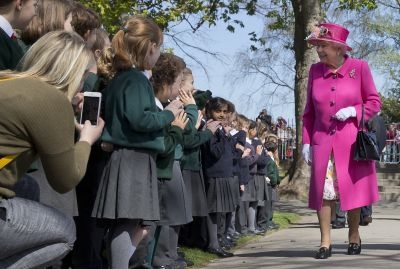 Britain's Queen Elizabeth II smiles as she is greeted by school children as she arrives to open a bandstand at Alexandra Gardens in Windsor, west of London, on April 20, 2016, the day before her 90th birthday.