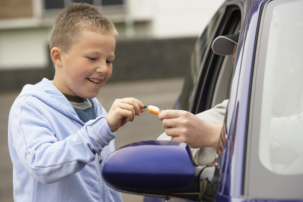 Boy taking candy from stranger