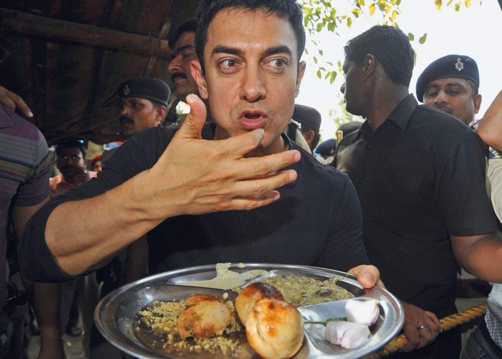 Bollywood actor Amir Khan is eating Bihari food ‘Litti’ at road side Litti shop at Bailey Road in Patna. Photo by - Sonu Kishan.