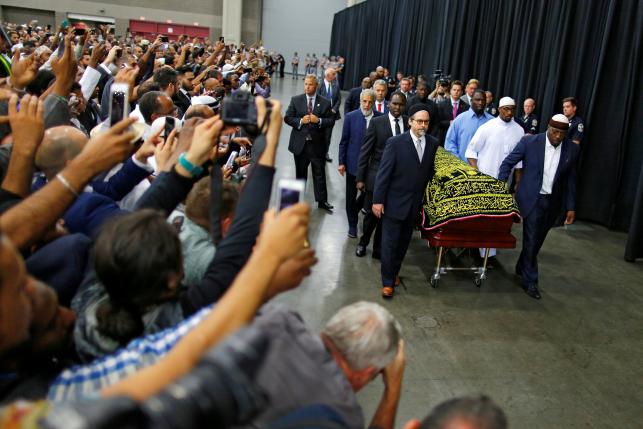 Worshipers and well-wishers take photographs as the casket with the body of the late boxing champion Muhammad Ali is brought for his jenazah, an Islamic funeral prayer, in Louisville, Kentucky, U.S. June 9, 2016. REUTERS/Carlos Barria