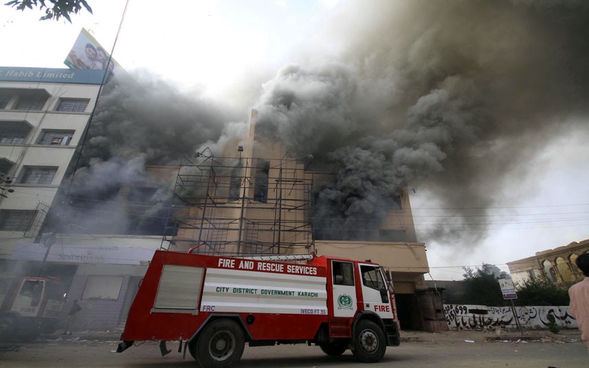 Pakistan urges calm amid protests over anti-Islam video...epa03405506 Palls of smoke pour out of a building after a mob started fires  during a protest against the anti-Islam movie entitled 'Innocence of Muslims' made in the US, in Karachi, Pakistan, 21 September 2012. Pakistan's Prime Minister condemned on 21 September the  video insulting the Muslim Prophet Mohammed as 'the worst kind of bigotry' and defended ongoing public protests. President Asif Ali Zardari was to convey Pakistan's outrage at an upcoming session of the UN General Assembly in New York, as Islamabad coordinates with other Muslim countries for a united reaction, Ashraf said. The prime minister demanded that the UN and other international organizations seek a law to ban hate speech, defined as 'fomenting hatred and sowing the seeds of discord'.  EPA/REHAN KHAN