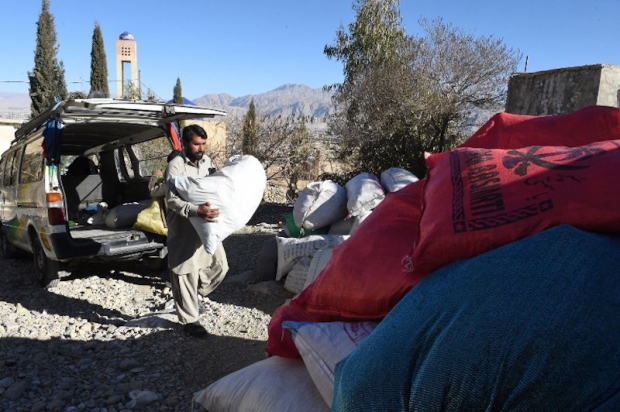 A Pakistani volunteer unloads a sack containing old copies of the Quran from a van at Jabl-e-Noor after collecting them from different places in the outskirts of Quetta January 14, 2016.