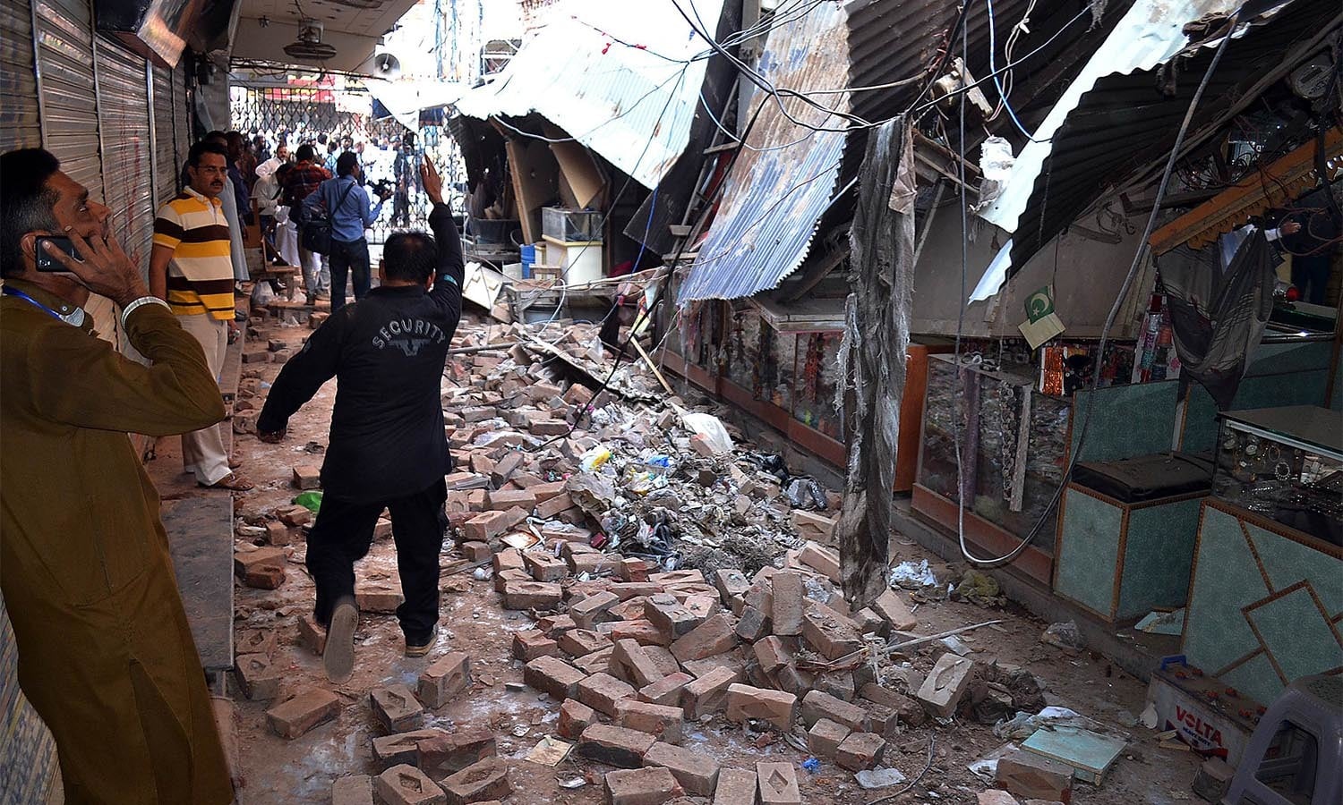 Pakistani residents gather at a damaged market following an earthquake in Sargodha on October 26, 2015. A powerful 7.5 magnitude earthquake killed at least 70 people as it rocked south Asia, including 12 Afghan girls crushed to death in a stampede as they tried to flee their collapsing school. Thousands of frightened people rushed into the streets in Afghanistan, Pakistan and India as the quake shook a swathe of the subcontinent. AFP PHOTO / SHAHID BUKHARI
