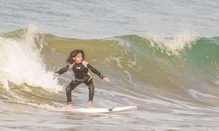 The 9 year old surfing