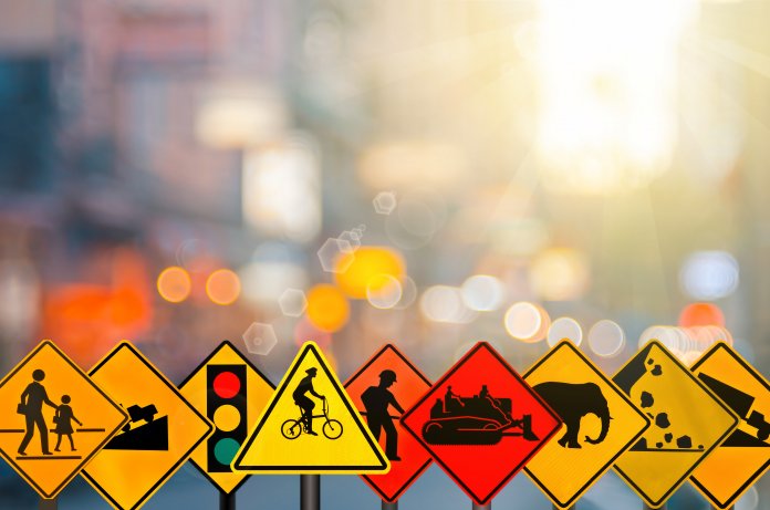 Set Of Traffic Warning Sign On Blur Traffic Road With Colorful B