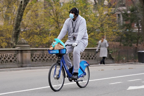 A man cycling in NYC during lockdown