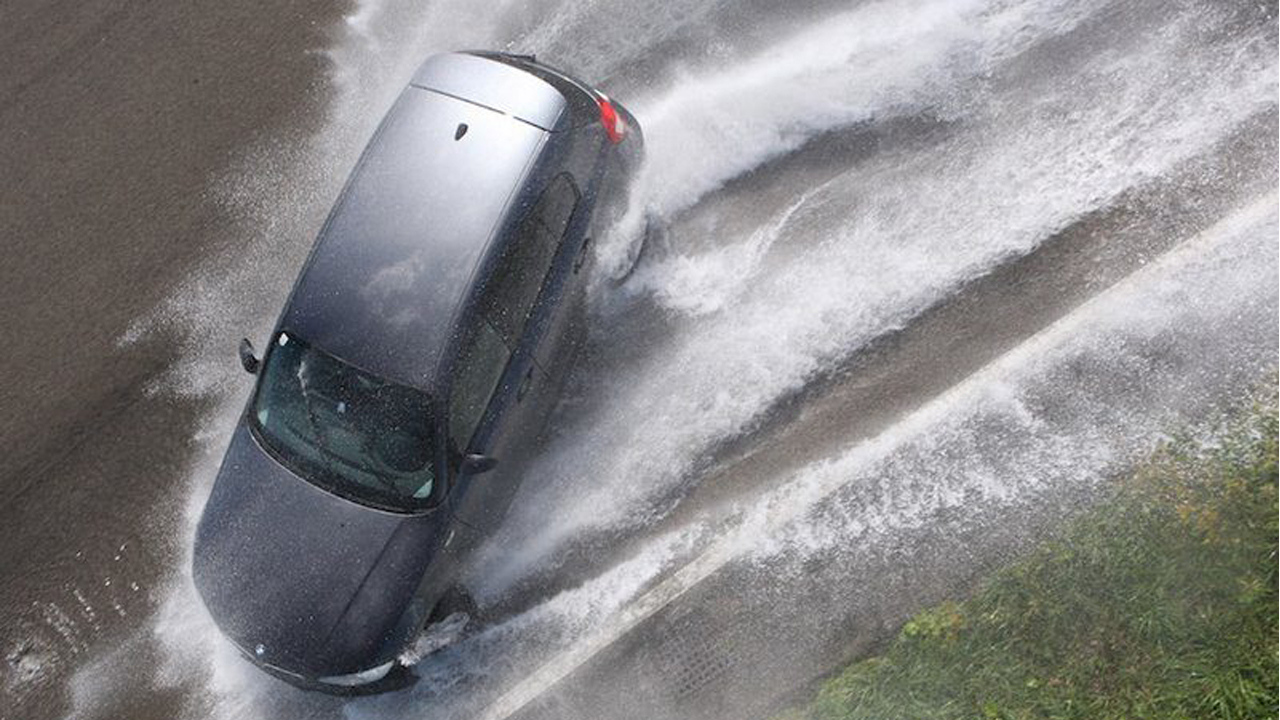 hydroplaning car in bad weather and controlling