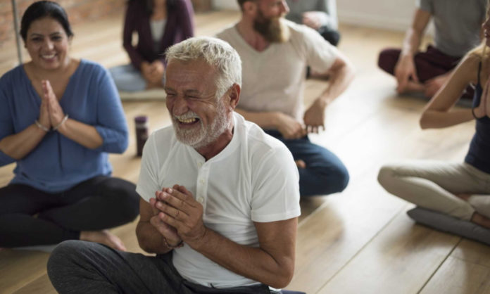 What Is Laughter Yoga? Here's What You Need To Know