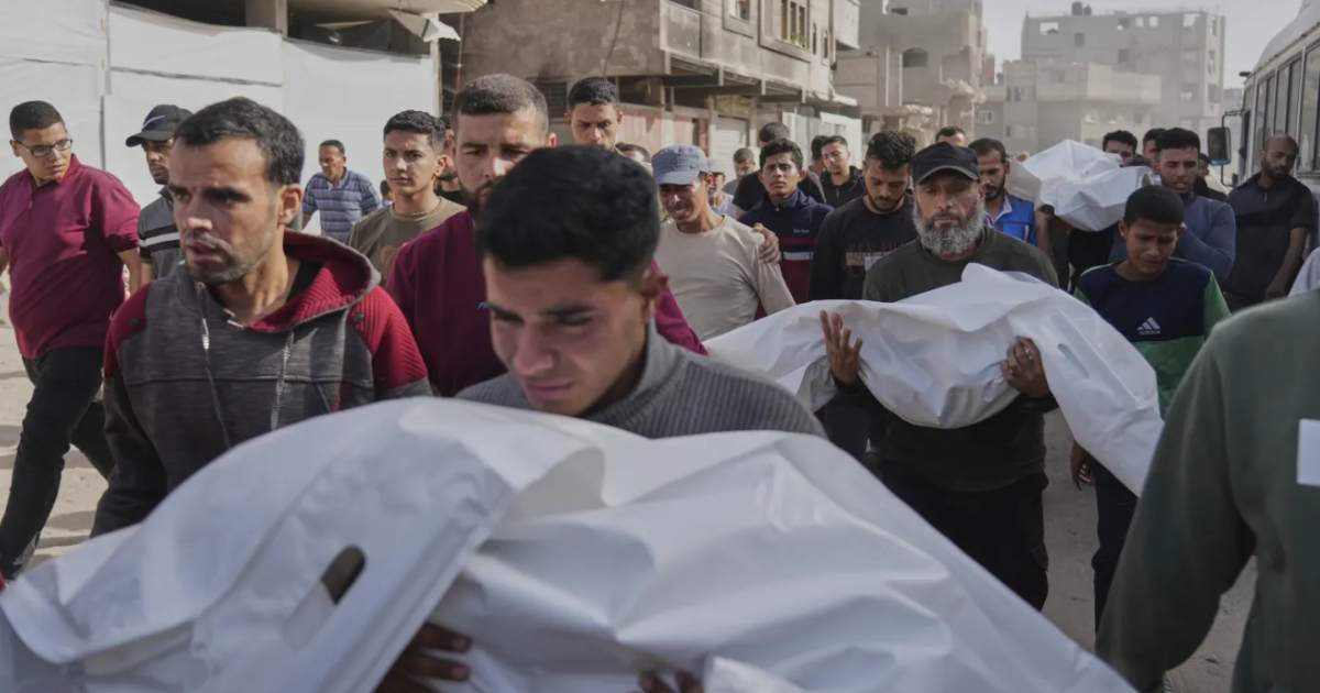 Palestinians carry the bodies of those who were killed in overnight strikes by Israel.