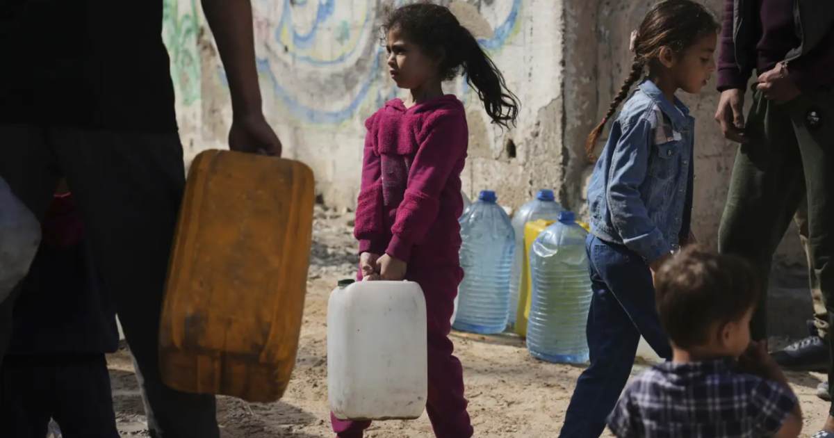 Palestinians collect water in Gaza city.