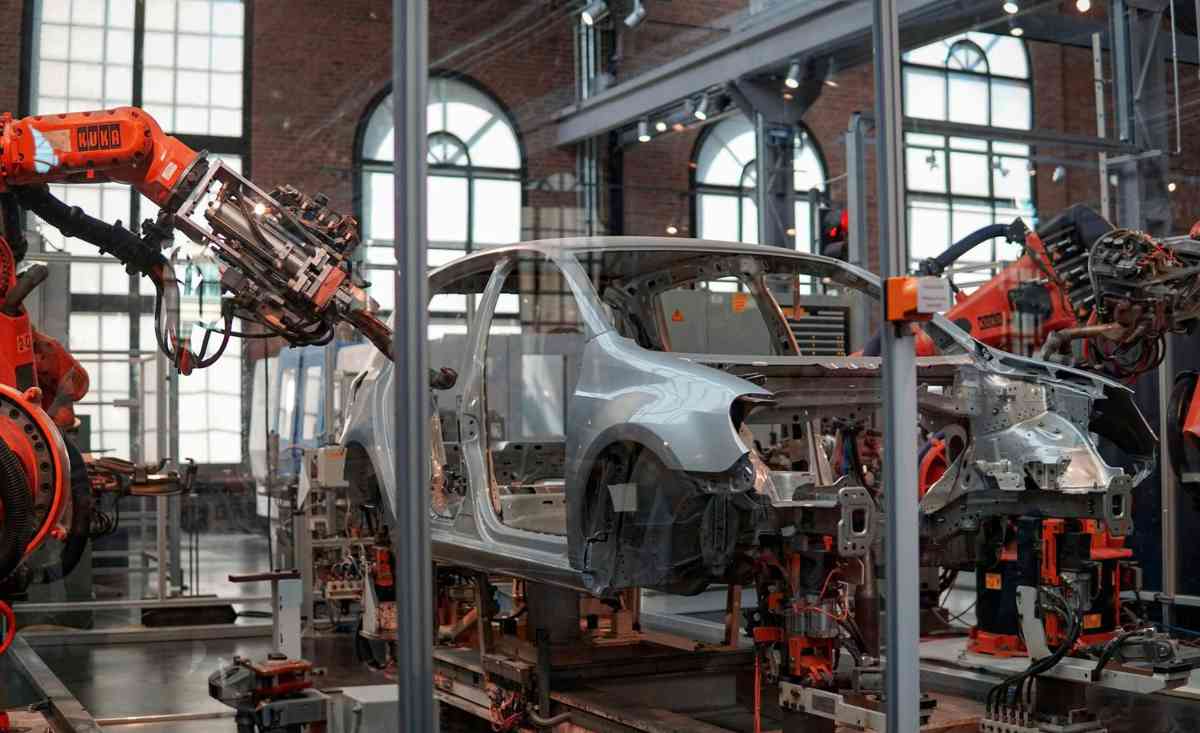 photo-of-a-car-being-assembled-by-robotic-arms